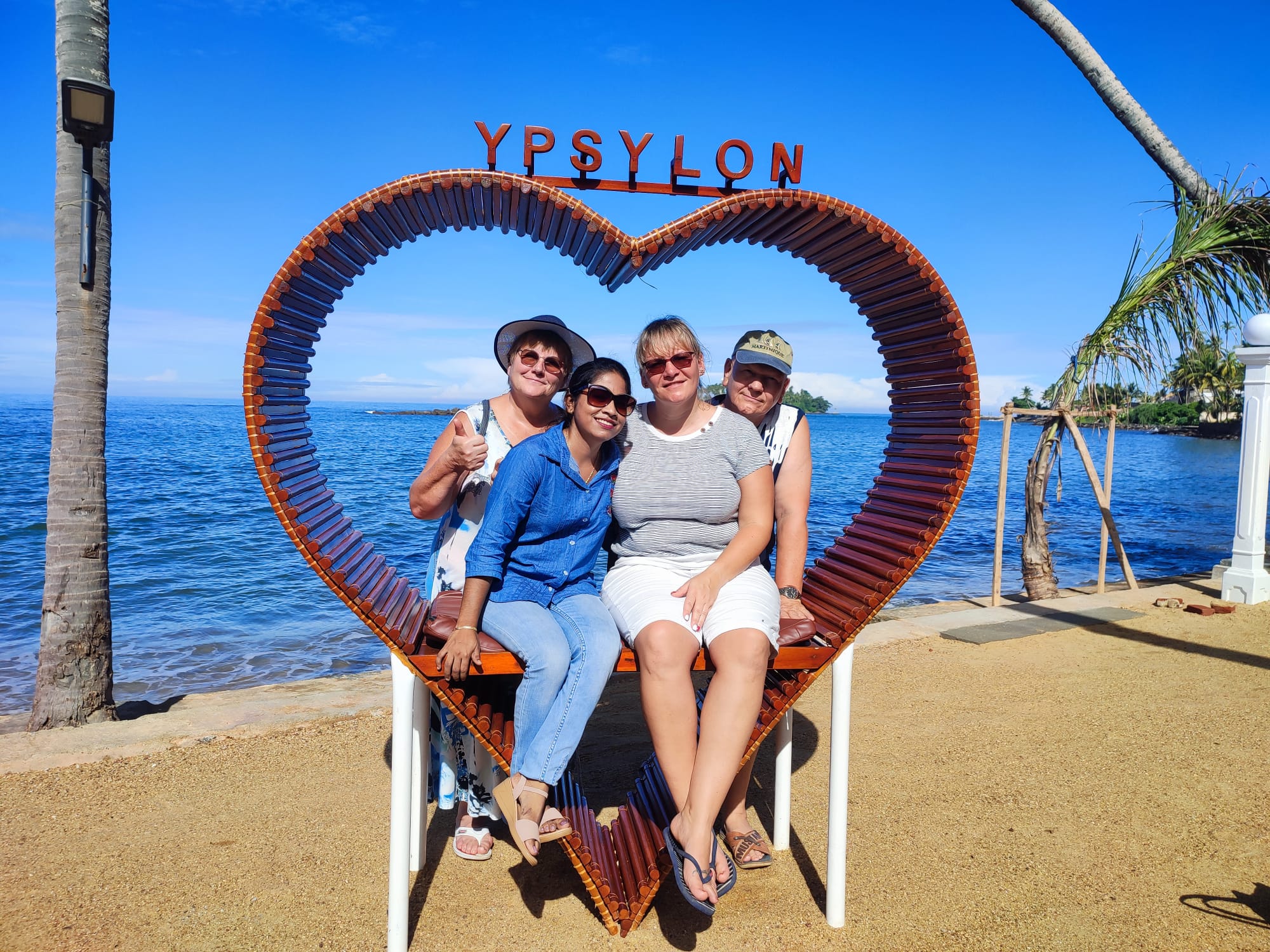 Guests enjoying a bright beachside group photo at Ypsylon in Sri Lanka
