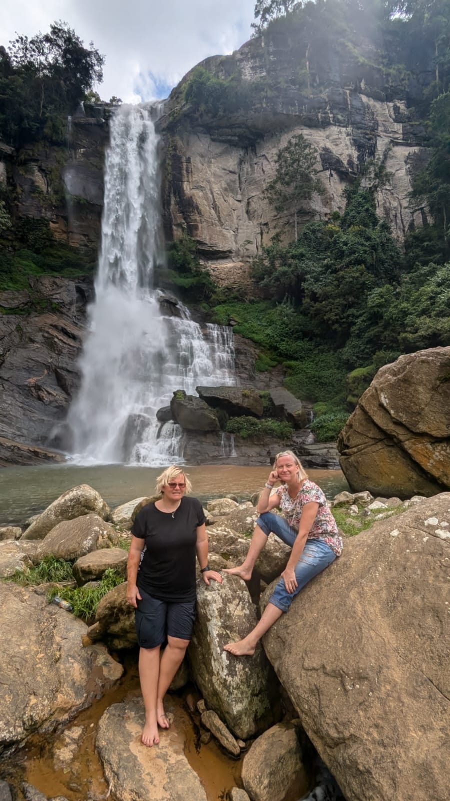 Guests relaxing by a spectacular waterfall during a Sri Lanka hill country tour