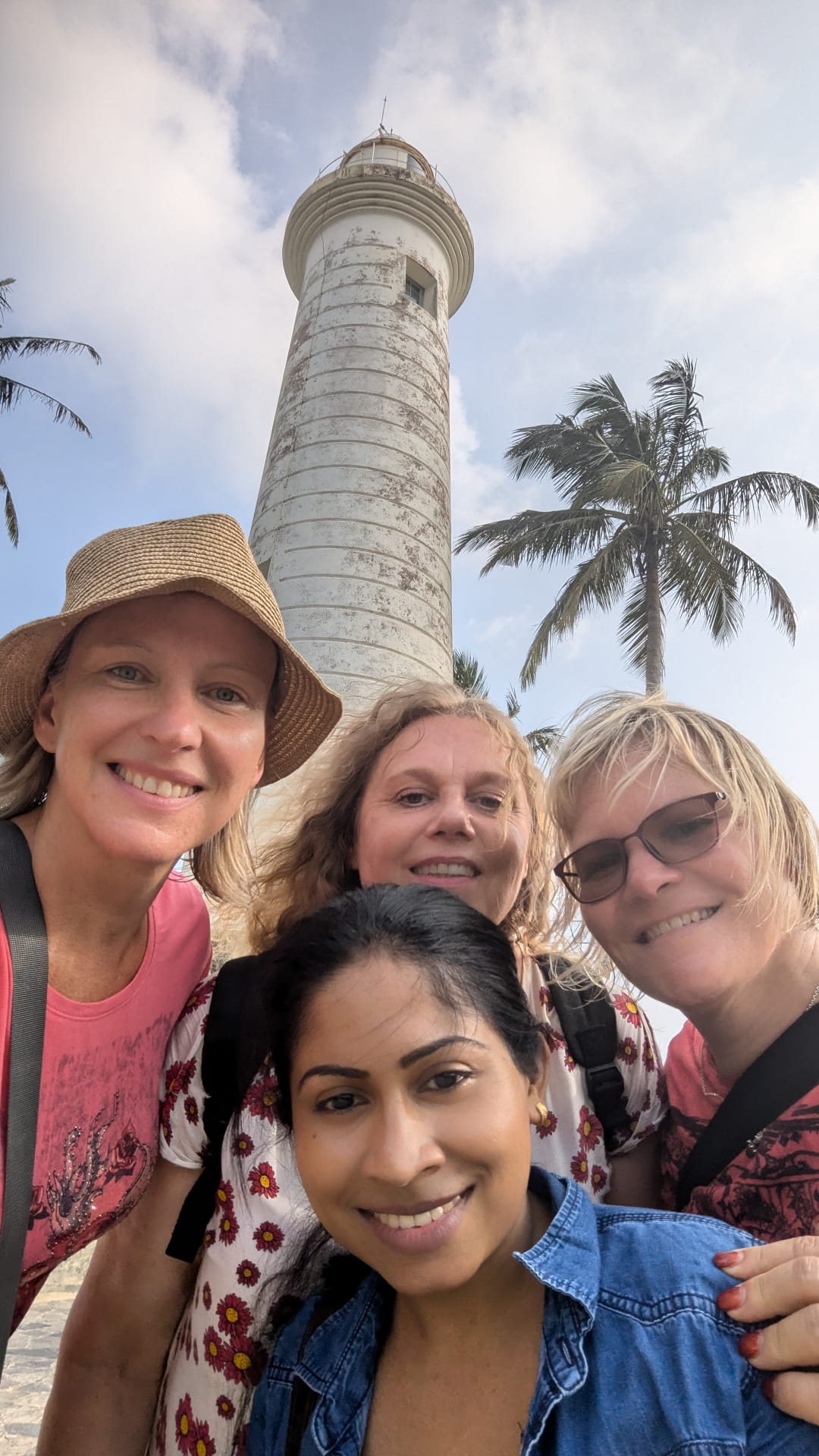 Guests and their local host taking a group selfie at the Galle Fort lighthouse