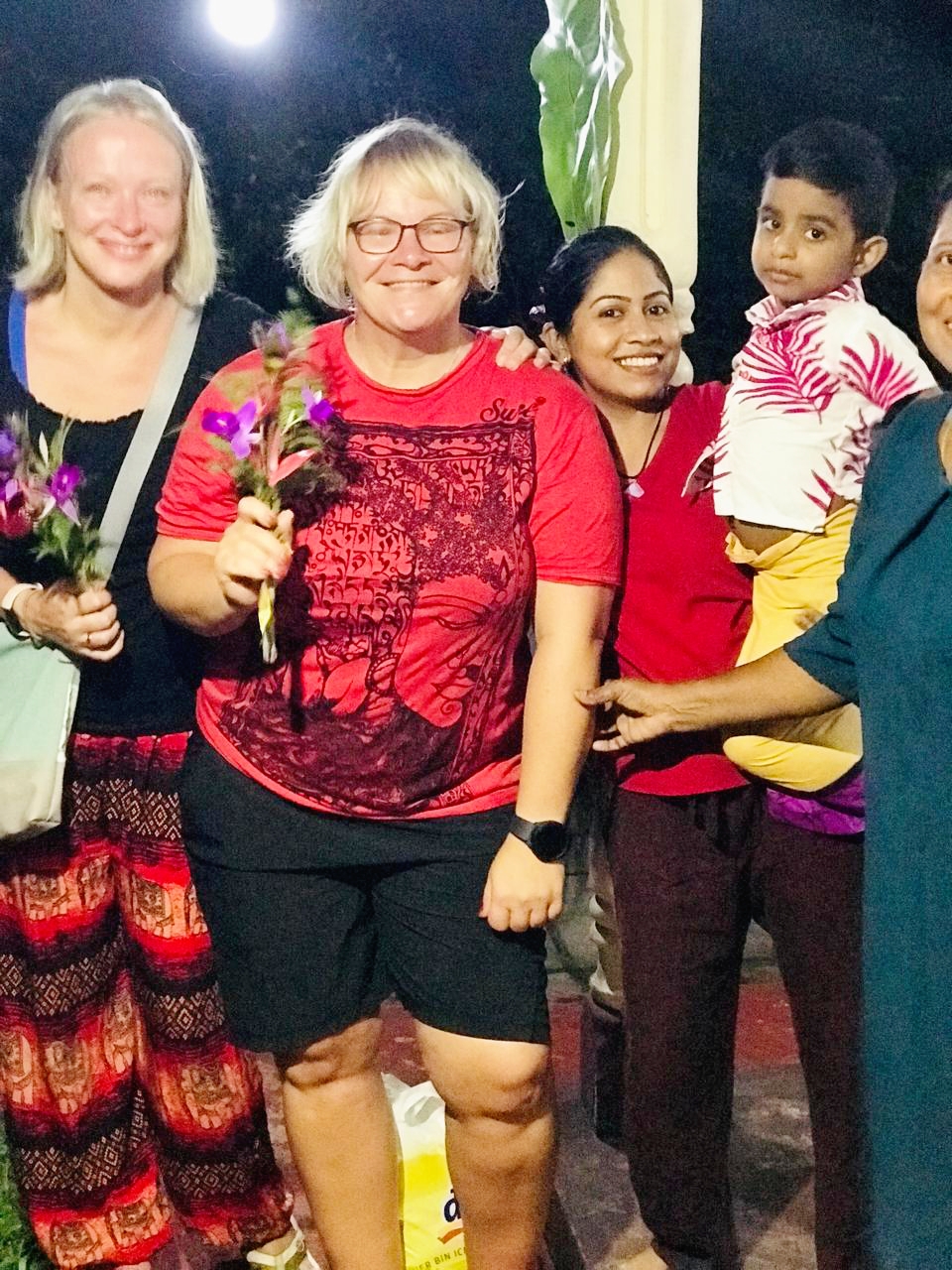 Guests receiving flowers from local hosts during their Sri Lanka tour