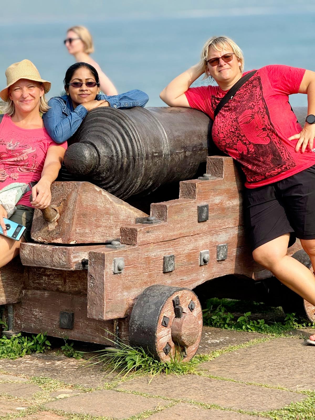 Guests visiting a historic cannon overlooking the sea at Galle Fort